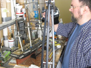 November 2012: Ken Bizarro of New Bedford, Massachusetts repairing the rigging on ship model U.S.S. Cyane. 
